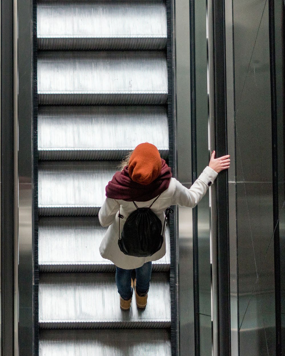 Lady-with-red-hat-on-escalator