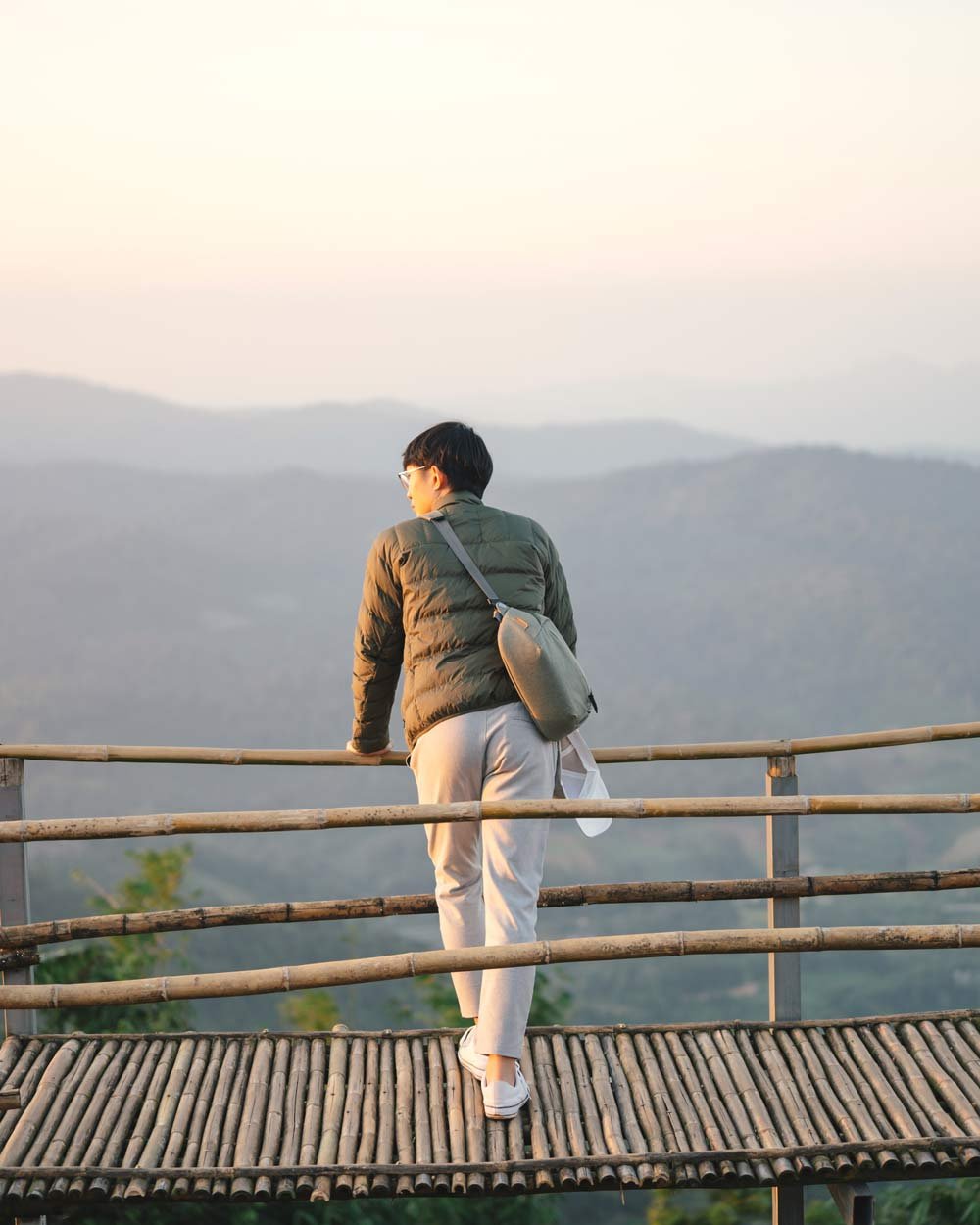 Man-looking-at-sky-over-bridge